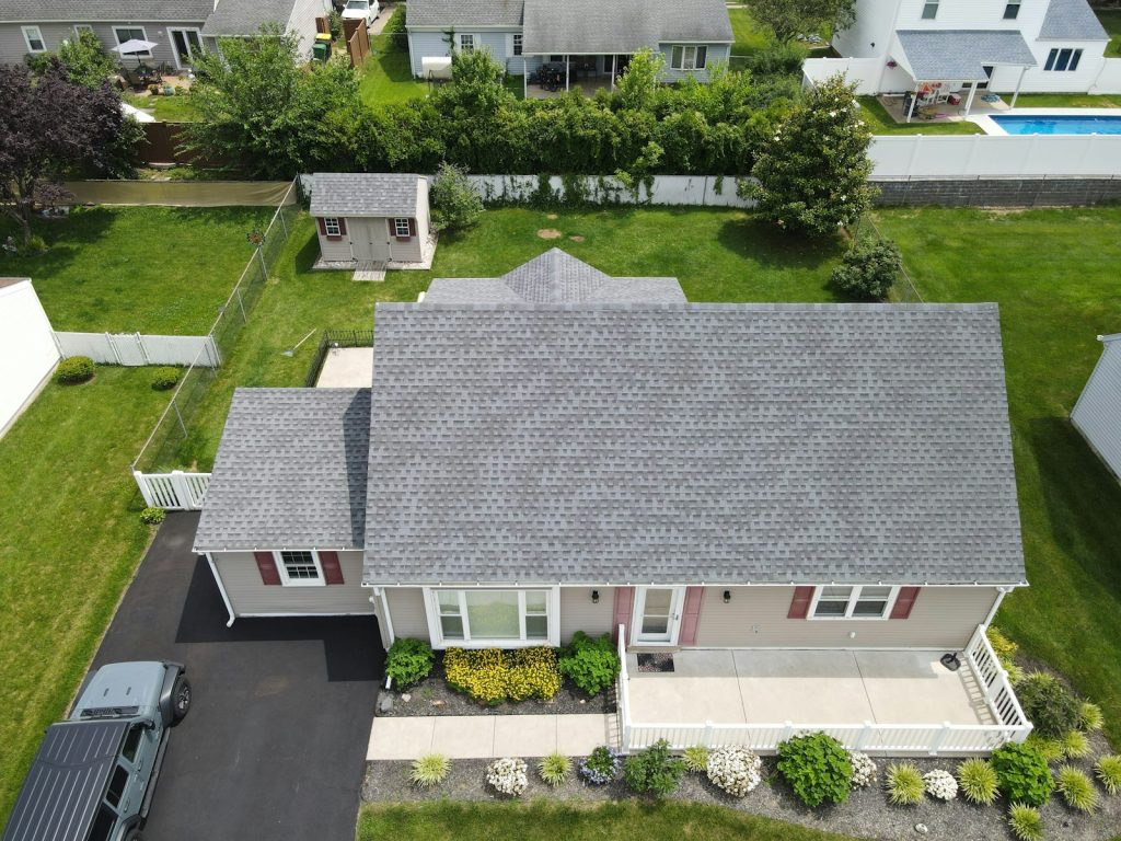 A suburban home with a clean grey asphalt shingle roof after professional roof soft washing in Indianapolis