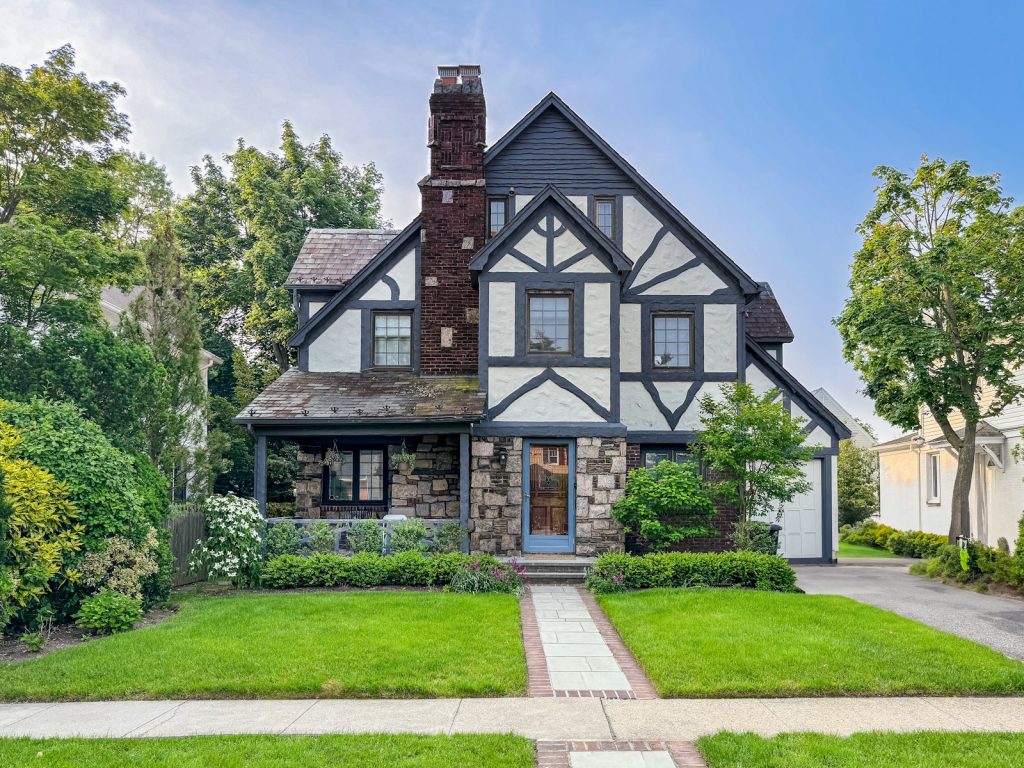 A tudor-style suburban home with a well-kept yard in Carmel, Indiana
